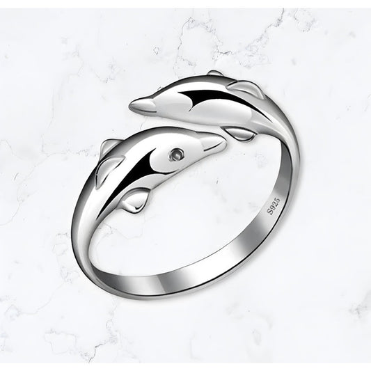 A Gemineye Jewellery Silver Dolphin Ring adorned with two elegant dolphins. Gold bracelets for women, gold earrings for women, gold bangle, silver bracelet for women, silver, earrings for women, silver rings for women, silver necklace women